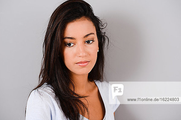 isolated studio shot of a beautiful and cheerful young brunette woman