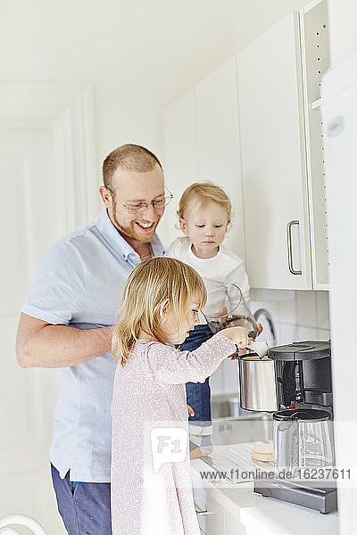 Father with children in kitchen