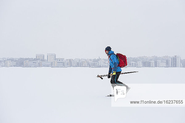 Man ice-skating on frozen lake