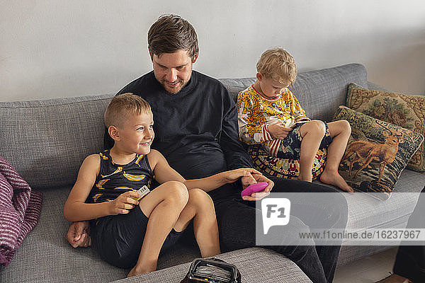 Father with sons on sofa