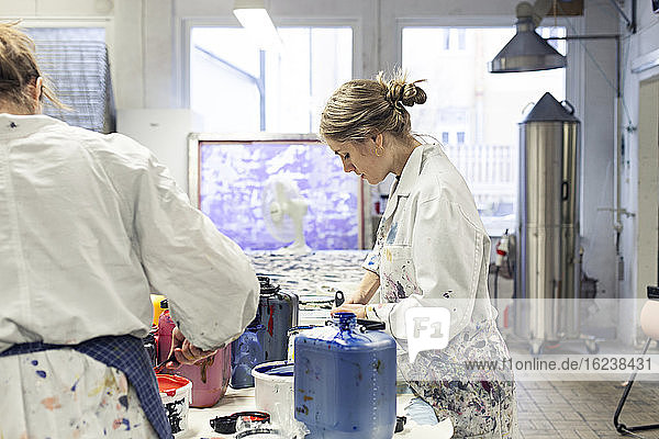 Women mixing paints in workshop