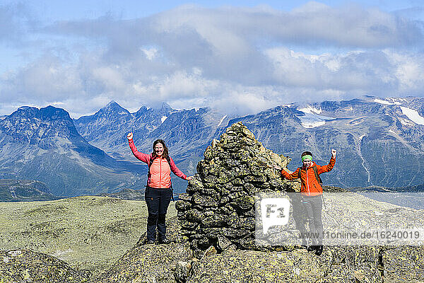 Woman on top of mountain