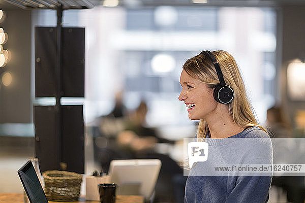 Woman wearing headset in office