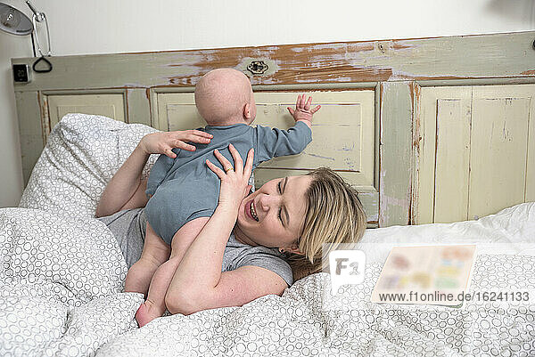 Mother with baby on bed