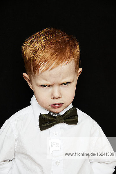 Portrait of boy making angry face