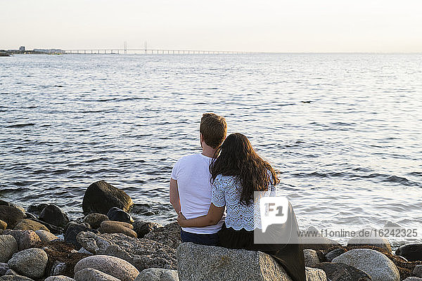 Young couple looking at sea