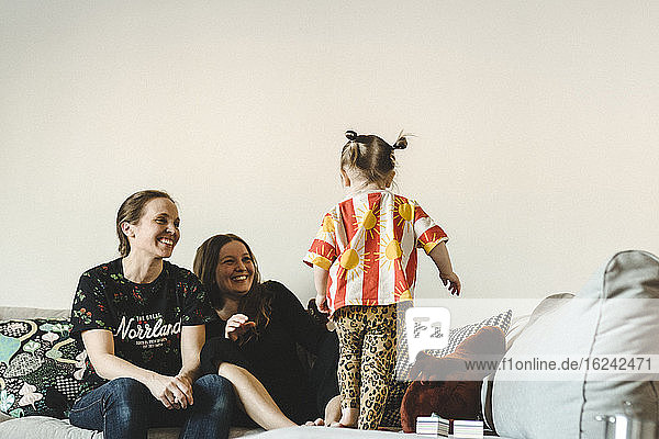 Girl with mothers on sofa
