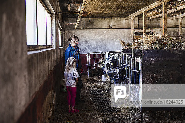Großmutter mit Enkelin im Kuhstall