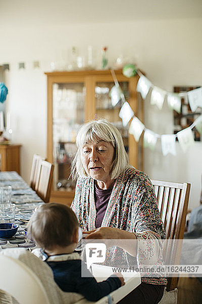 Grandmother feeding grandchild