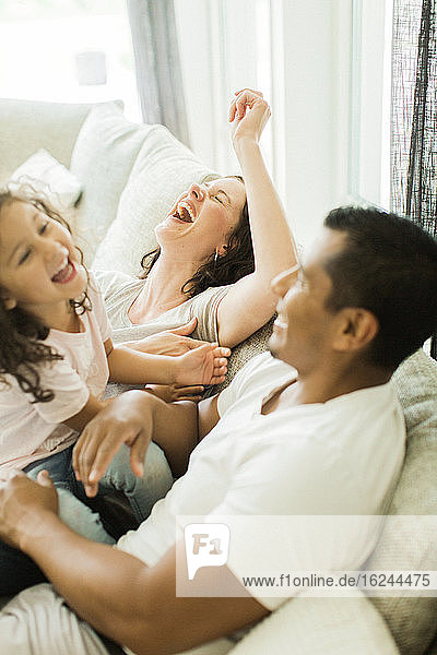 Parents with daughter laughing