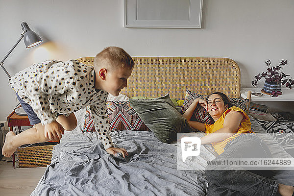 Mother with son on bed