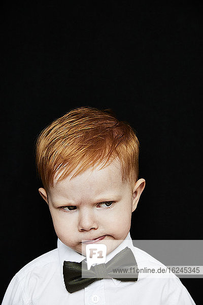 Portrait of boy frowning