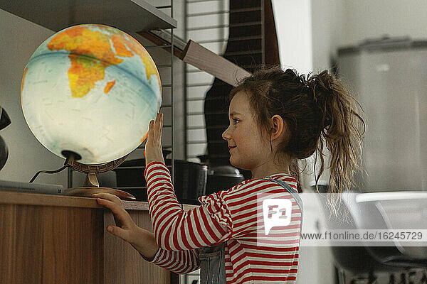 Girl looking at globe