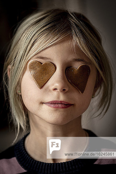 Girl with gingerbread heart on her eyes