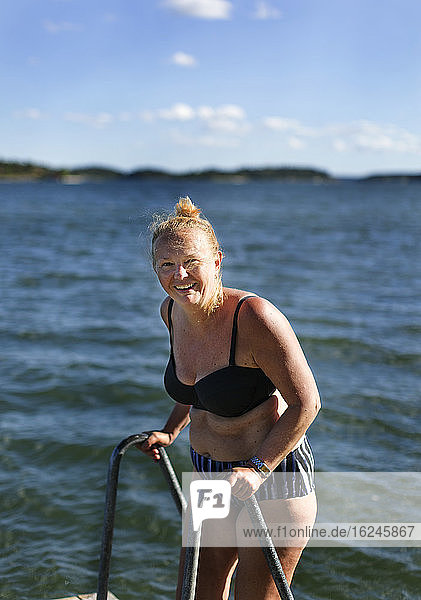 Smiling woman standing in bikini