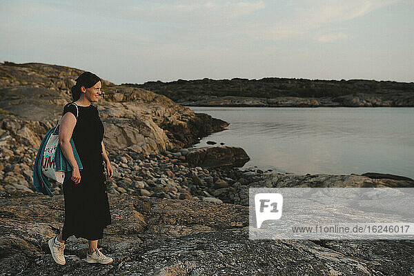 Woman standing on rocky coast