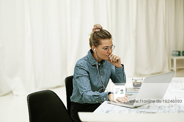 Businesswoman using laptop in office