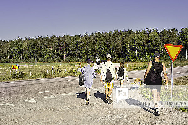 People walking along country road