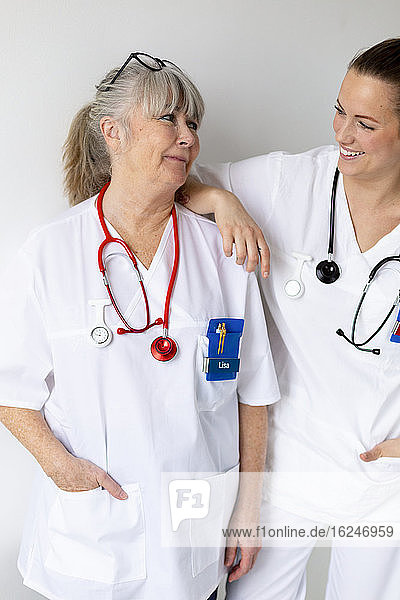 Smiling female doctors talking