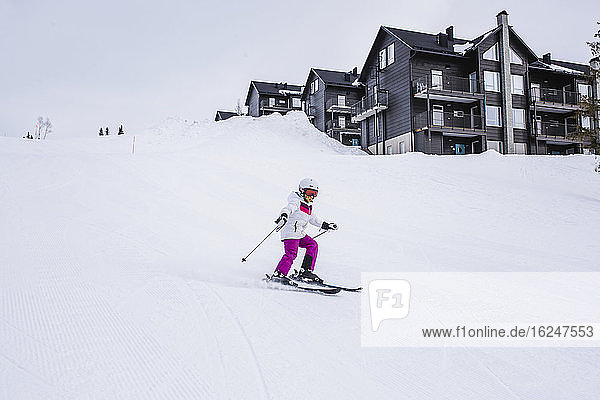 Girl skiing on ski slope