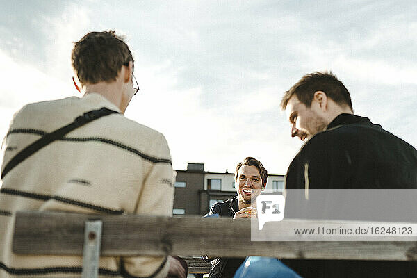 Smiling friends talking