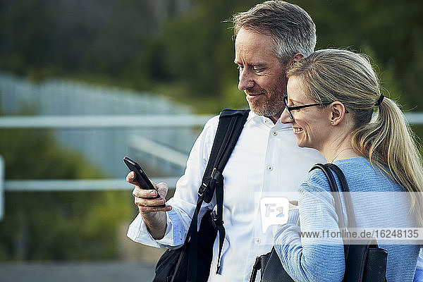 Smiling couple looking at cell phone