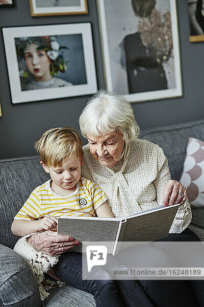 Grandmother reading book to grandson