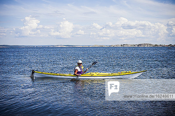 Woman kayaking on sea