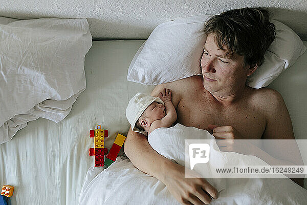 Father with baby in bed