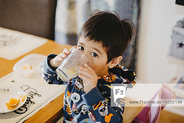 Boy at table drinking