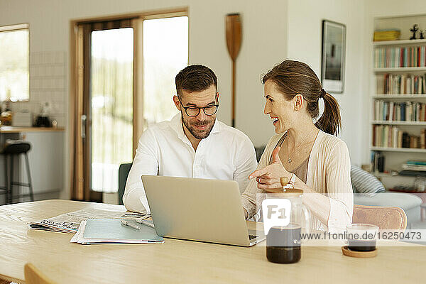 Couple working together at home