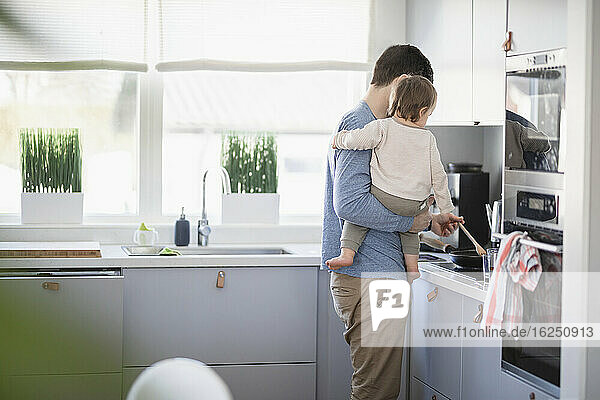 Father with baby in kitchen