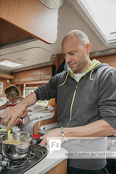 Man preparing food in camper van