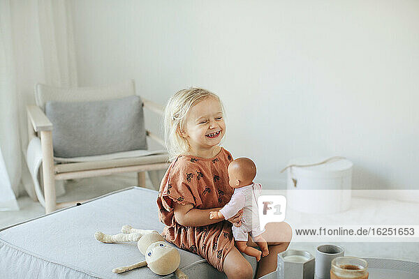 Girl playing with doll