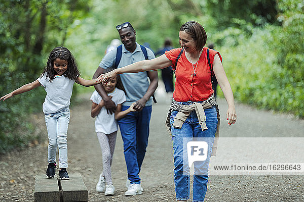 Happy family walking on park trail