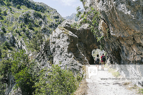 Hikers walking on mountain path at Ruta Del Cares  Asturias  Spain