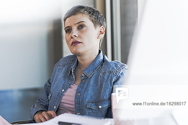 Businesswoman thinking at desk in office