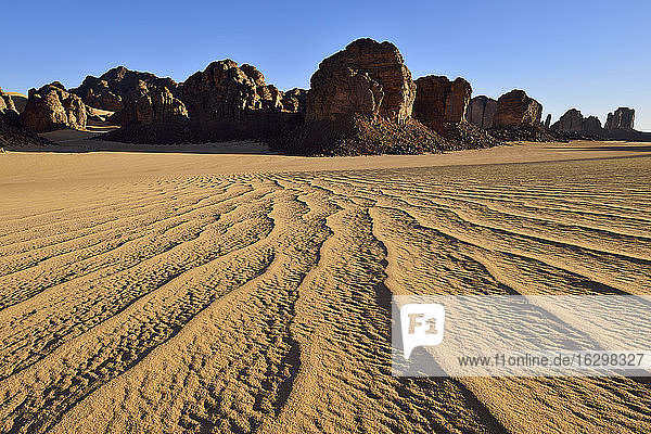 Africa  Algeria  Sahara  Tassili N'Ajjer National Park  Sand dunes and rock formations at Tikobaouine
