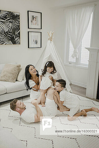 Playful happy family enjoying in living room at home