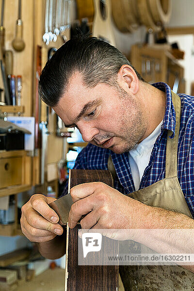 Guitar maker in his workshop
