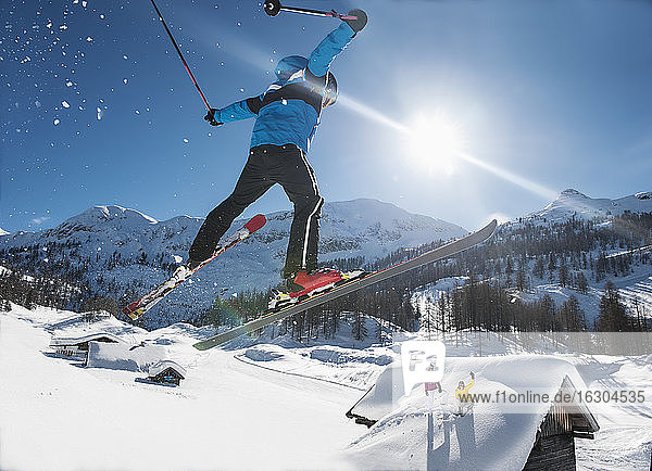 Austria  Salzburg  Young man ski jumping in mountains
