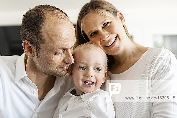 Smiling parents with baby boy at home