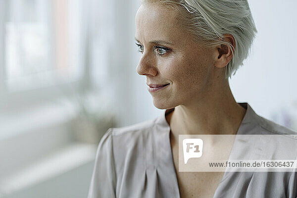 Close-up of thoughtful businesswoman looking away in loft office