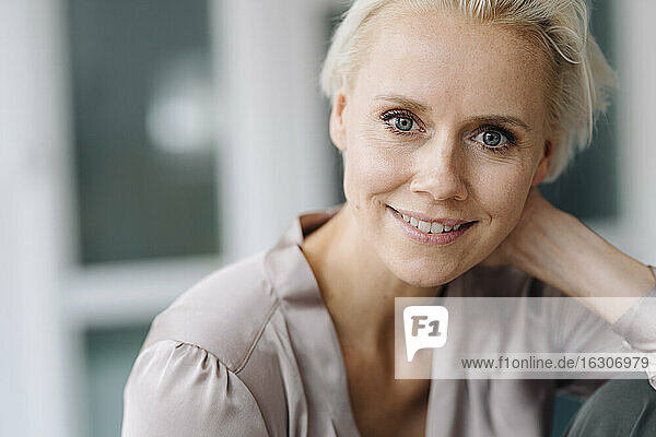 Close-up portrait of smiling businesswoman in office