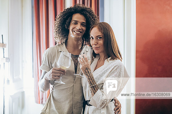 Couple with wineglass during party at home