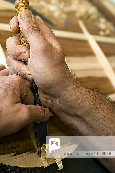 Guitar maker in his workshop  close-up
