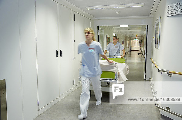 Germany  Freiburg  Nurses moving hospital bed