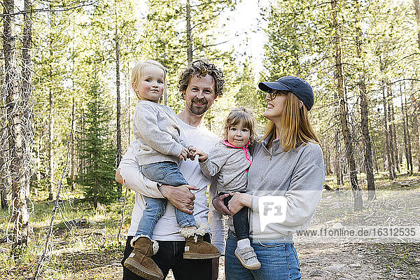Parents with little daughters (2-3) standing on path in Uinta-Wasatch-Cache National Forest