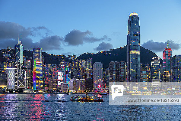 Star Ferry in Victoria Harbour and skyline of Hong Kong Island at dusk  Hong Kong  China  Asia