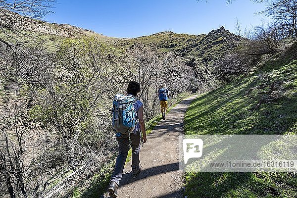 Two hikers on hiking trail Vereda de la Estrella  Sierra Nevada  mountains near Granada  Andalusia  Spain  Europe